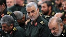 FILE - In this Sept. 18, 2016 photo released by the office of Iran's supreme leader, Revolutionary Guard Gen. Qassem Soleimani, center, attends a meeting with Supreme Leader Ayatollah Ali Khamenei in Tehran.