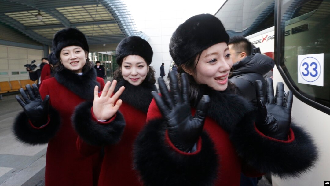 North Korean cheering squads wave upon their arrival at the Korean-transit office near the Demilitarized Zone in Paju, South Korea, Feb. 7, 2018. 