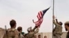 A U.S. flag is lowered as American and Afghan soldiers attend a handover ceremony from the U.S. Army to the Afghan National Army, at Camp Anthonic, in Helmand province, southern Afghanistan, May 2, 2021.