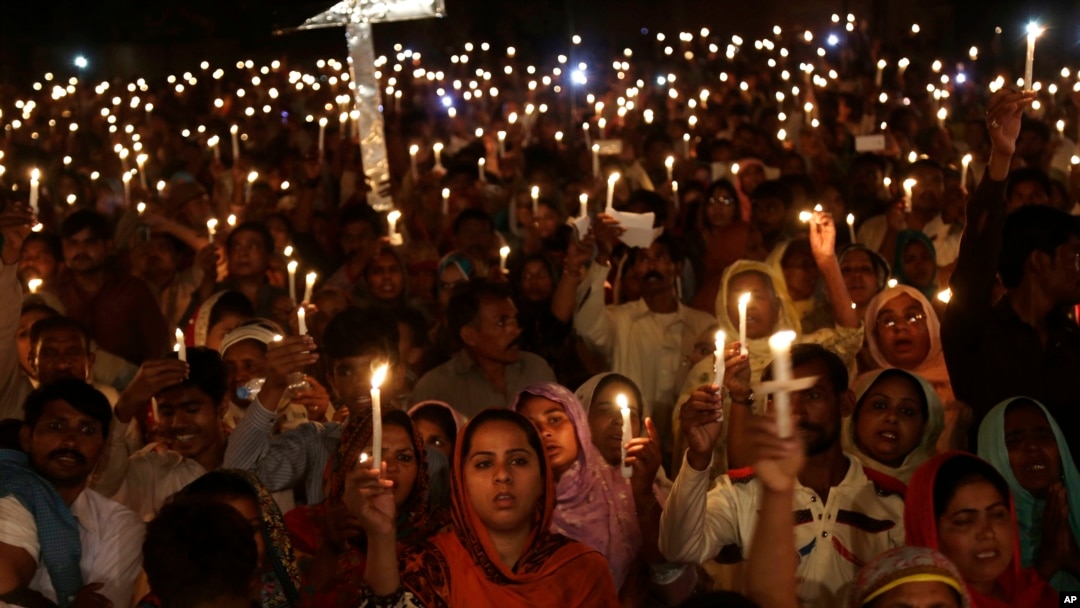 FILE - Pakistani Christians hold candles during a vigil for victims of a deadly suicide bombing on March 27 in Lahore, Pakistan, March 30, 2016. 