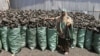 Sacks of dark charcoal sit atop one another in Somalia's southern port city of Kismayo, an industry once worth some $25 million dollar a year to al-Qaida-linked insurgents, Oct. 30, 2012.