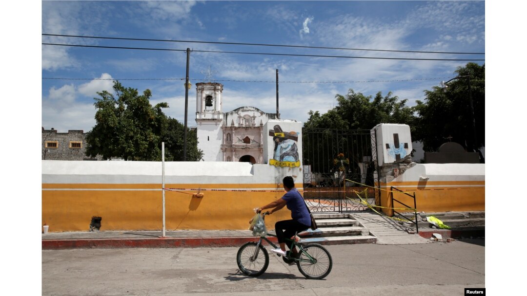 A man rides a bicycle past a church dome which collapsed in an earthquake is seen in Axochiapan, near Mexico City, Mexico September 29, 2017. REUTERS/Henry Romero