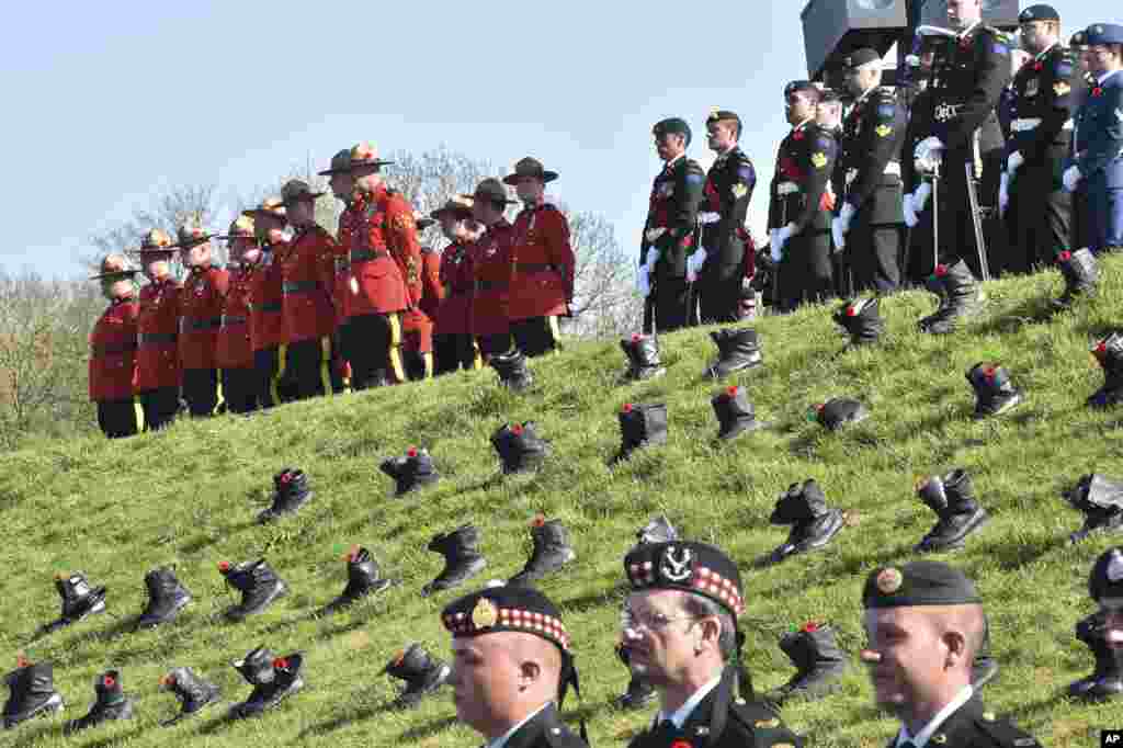 Soldiers and Royal Canadian Mounted Police officers mark the 100th anniversary of the Battle of Vimy Ridge at the WWI Canadian National Vimy Memorial in Vimy, France.