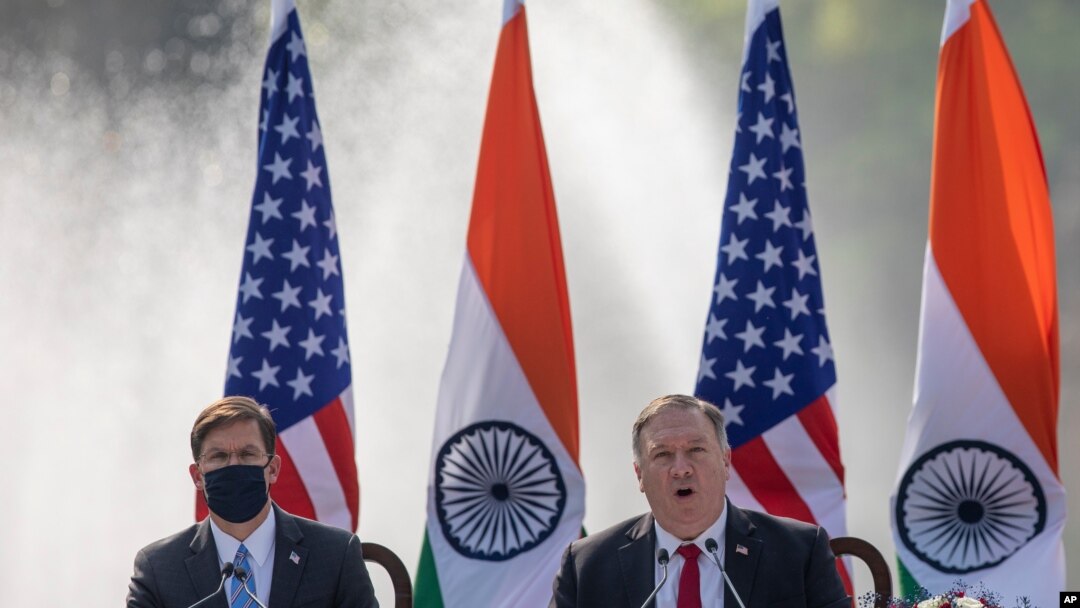 U.S. Secretary of State Mike Pompeo, right, speaks with Secretary of Defence Mark Esper seated beside him during a joint press conference with their Indian counterparts at Hyderabad House in New Delhi, India, Oct. 27, 2020.