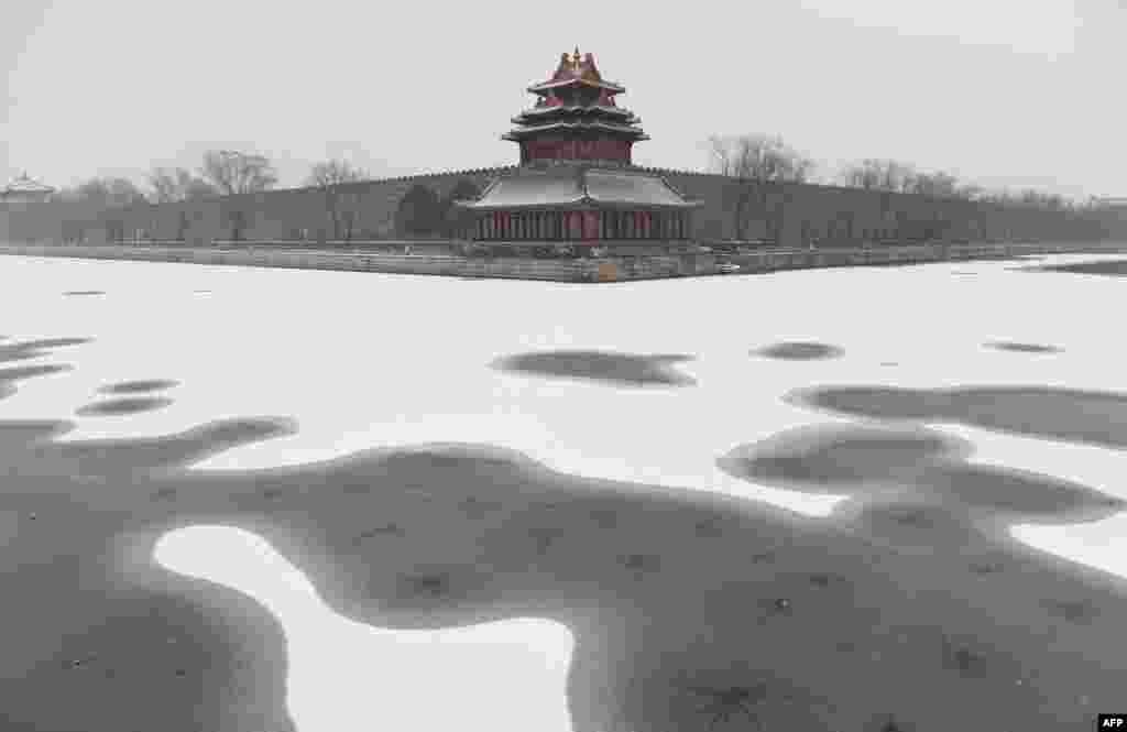 Snow is seen in the moat surrounding the Forbidden City during a snowfall in Beijing, China.