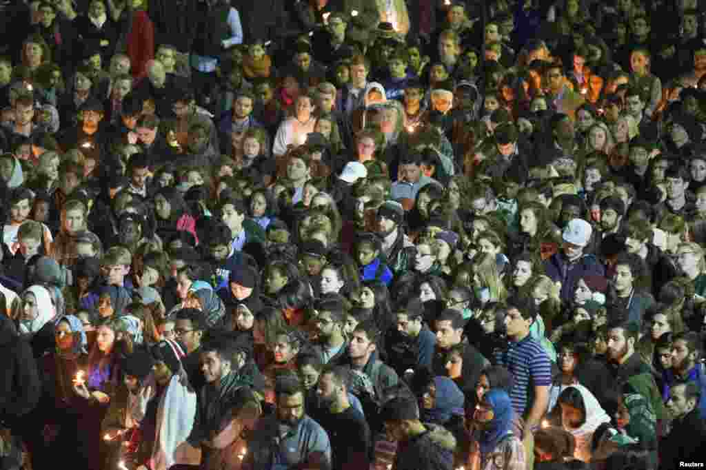 Students gather during a vigil on the campus of the University of North Carolina for Deah Shaddy Barakat, his wife, Yusor Abu-Salha, and Yusor's sister Razan Abu-Salha, who were killed in Chapel Hill, N.C., Feb. 11, 2015.