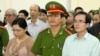 FILE - A U.S-trained lawyer and well-known dissident Le Quoc Quan, right, listens to the judge during his trial in Hanoi, Vietnam.