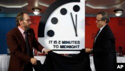 Robert Rosner, chairman of the Bulletin of the Atomic Scientists, right, and Bulletin of the Atomic Scientists member Lawrence Krauss, left, unveil the Doomsday Clock during a news conference at the National Press Club in Washington, Jan. 25, 2018. 