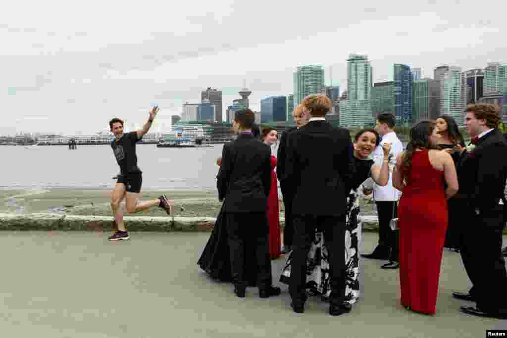 Prime Minister Justin Trudeau jogs past a group of high school students dressed for their prom in Vancouver, British Columbia, Canada.