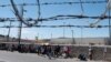 Migrants gather along the U.S. Mexico border near El Paso before the lifting of Tile 42