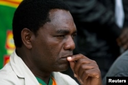 FILE - The United Party for National Development's Hakainde Hichilema looks on during a rally in Lusaka, Jan. 18, 2015.