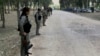 FILE - Kurdish Democratic Union Party (PYD) members stand guard during a Labour Day celebration in Efrin, Syria, May 1, 2014.