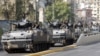 Lebanese army convoy secures portions of Beirut after a night of violent clashes, October 22, 2012.