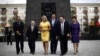 U.S. Republican Presidential candidate Mitt Romney and his wife Ann walk with dignitaries as they visit the monument to the Ghetto Heroes in Warsaw, July 31, 2012. 