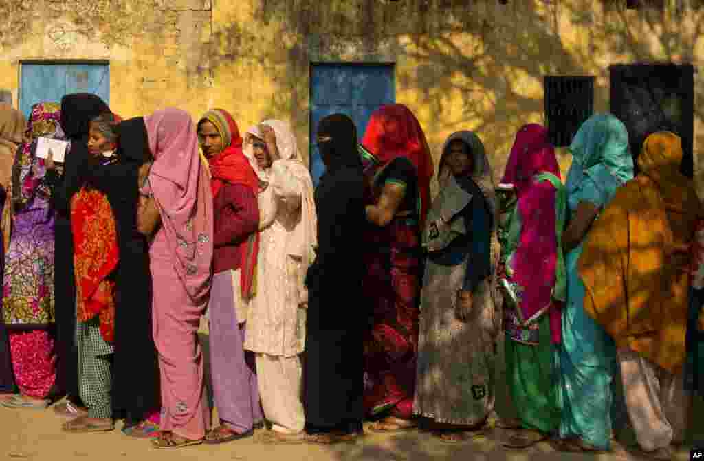Women stand in a queue to cast their votes at a village near Amroha in Uttar Pradesh, India. Uttar Pradesh and four other Indian states are having state legislature elections in February-March, a key mid-term test for Prime Minister Narendra Modi's Hindu nationalist government.