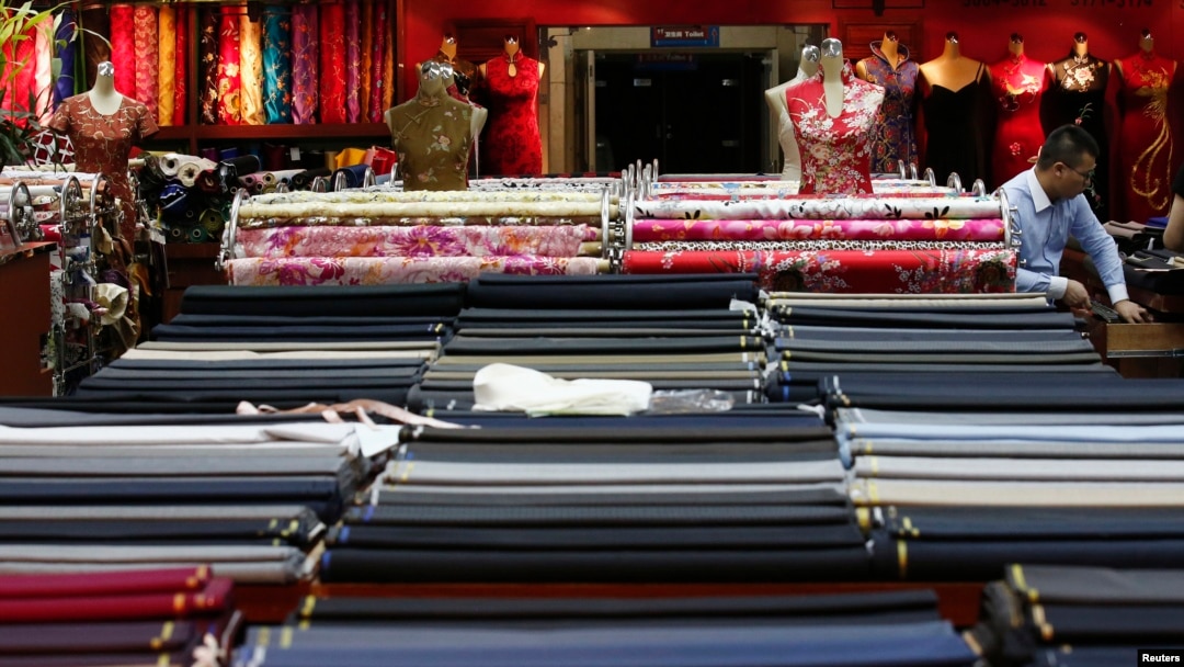 FILE - An employee works in a clothing shop in Beijing, China.