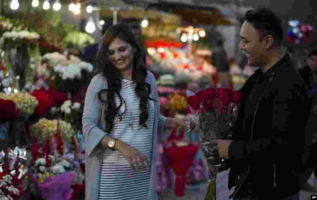 A couple buy flowers to celebrate Valentine's Day, in Islamabad, Pakistan. A judge has banned Valentine's Day celebrations in the country's capital, saying they are against Islamic teachings.