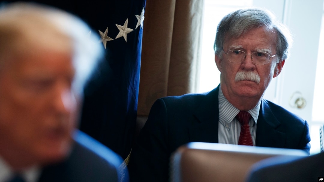 FILE - Then-National security adviser John Bolton listens as President Donald Trump speaks during a cabinet meeting at the White House in Washington, April 9, 2018.