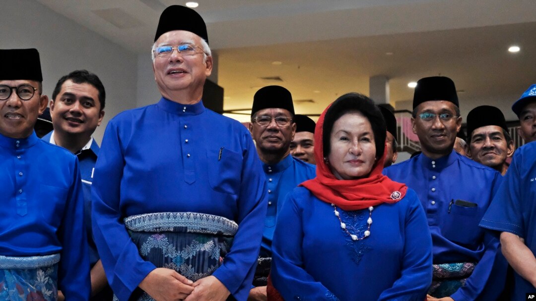 FILE - Former Malaysian Prime Minister Najib Razak, second left in front, and his wife Rosmah Mansor prepare to leave for an election nomination center in Pekan, Pahang state, Malaysia, April 28, 2018. 