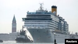 The Costa Deliziosa cruise ship passes in the Saint Mark Basin in Venice, Italy, June 9, 2019. Passengers on the ship's around-the-world cruise, begun before the coronavirus pandemic struck, are finally approaching the end of their voyage.