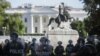 Washington, D.C., National Guard military police officers stand guard as demonstrators rally near the White House in Washington, June 1, 2020, against the death in Minneapolis police custody of George Floyd. 