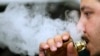 A man breathes vape from an e-cigarette at a vape shop in London, Aug. 17, 2018.