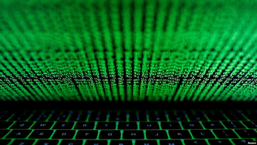 FILE- A computer keyboard lit by a displayed cyber code is seen in this illustration.