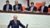 Prime Minister Ahmet Davutoglu (2nd R) and his ministers listen as lawmakers are sworn into office during a ceremony in Ankara, Turkey, June 23, 2015, in an early step in what could be a drawn-out coalition-building process.