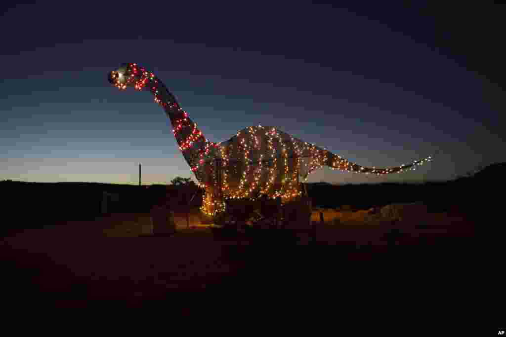 A dinosaur statue stands outside a store off the highway in Terlingua, Texas, near the U.S.-Mexico border, March 27, 2017.