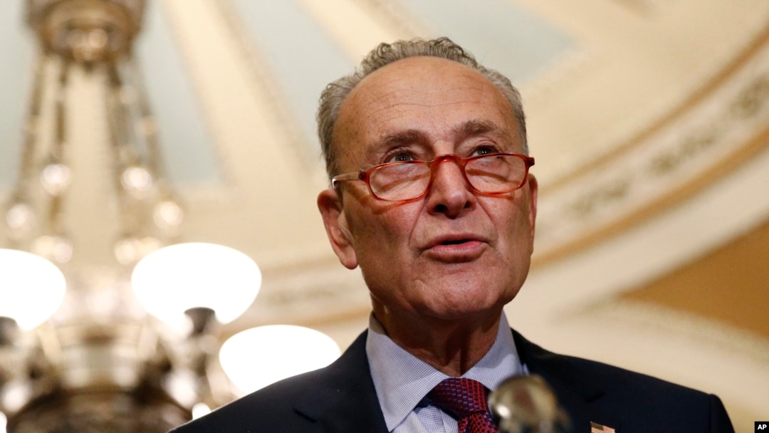 FILE - Senate Minority Leader Chuck Schumer speaks to reporters on Capitol Hill in Washington, Oct. 22, 2019. Schumer is proposing a trade-in program to get millions of Americans out of climate-damaging gas vehicles and into electric or hybrid cars.