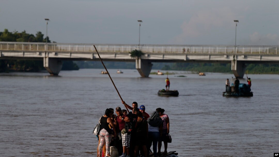 Migrants cross by raft from Tecun Uman, Guatemala, left, to Ciudad Hidalgo, Mexico, on June 14, 2019. 