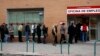 People wait in line to enter a government-run employment office in Madrid March 4, 2013.