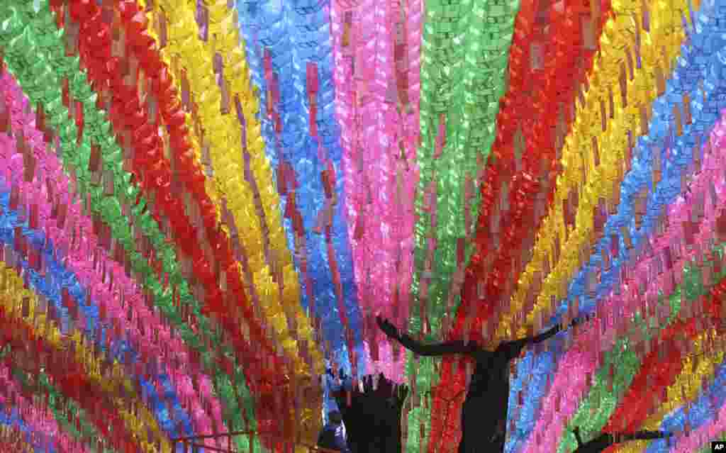 A worker checks the lanterns in preparation for the upcoming celebration of Buddha's birthday at the Jogye temple in Seoul, South Korea.