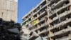 A Hezbollah flag flutters on one of the balconies of a building targeted by recent Israeli strikes in southern Beirut's Ruweiss district, Nov. 11, 2024, as the war continues between Israel and the Lebanese militant group.