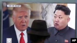 FILE - A man watches a TV screen showing U.S. President Donald Trump, left, and North Korean leader Kim Jong Un during a news program at the Seoul Train Station in Seoul, South Korea, Aug. 10, 2017. 