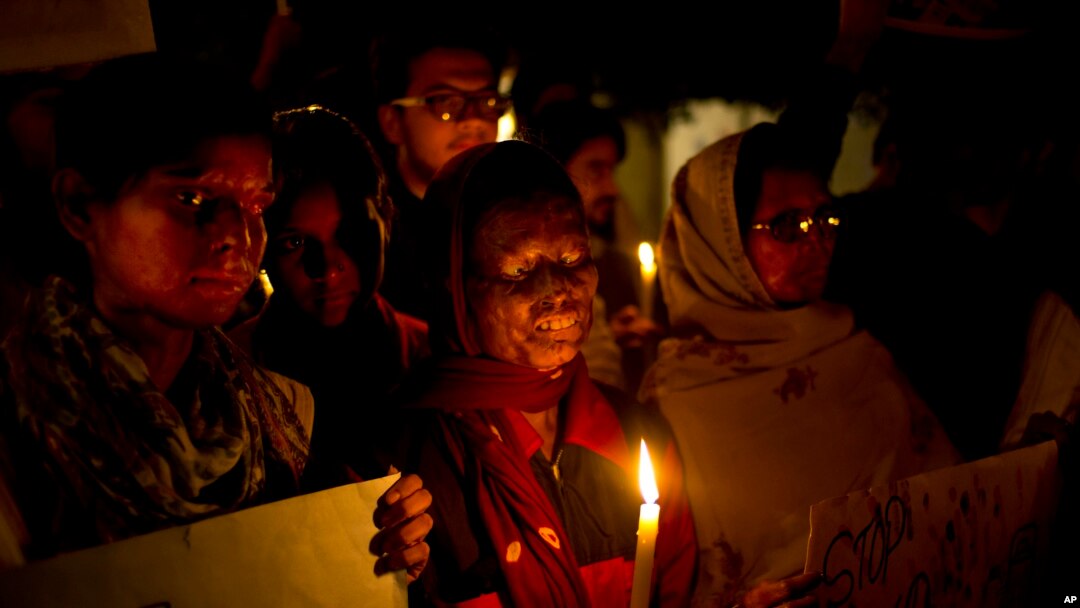India Acid Attack: FILE - In this Dec. 16, 2014 file photo, acid attack survivors participate in a candlelit vigil protesting violence against women as they mark the second anniversary of the deadly gang rape of a student on a bus, in New Delhi, India. 