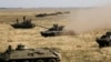 Ukrainian tanks and APCs move towards the de-facto border with Crimea near Kherson, southern Ukraine, Friday, Aug. 12, 2016.