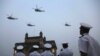 FILE - Indian navy personnel display their skills during a rehearsal for Naval Day celebrations near the Gateway of India monument in Mumbai, India, Dec. 1, 2019. 
