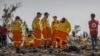 FILE - Investigators examine wreckage on March 12, 2019, at the scene of the Ethiopian Airlines Boeing 737 Max 8 crash near Bishoftu, or Debre Zeit, south of Addis Ababa, in Ethiopia. 