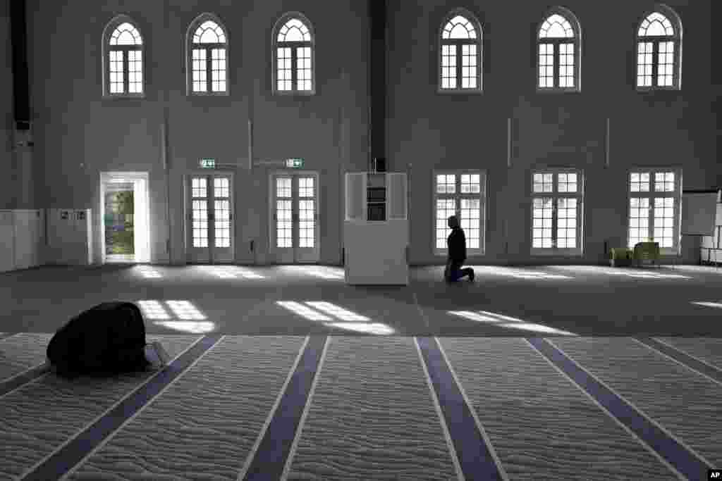 Muslim men pray in a mosque in Amsterdam, Netherlands.