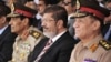 Former Egyptian Field Marshal Gen. Hussein Tantawi, left, President Mohammed Morsi, center, and Armed Forces Chief of Staff Sami Anan, right, Cairo, July 5, 2012.