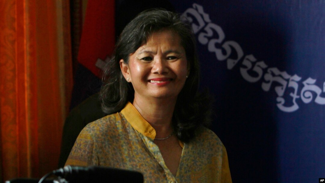 Parliament member Mu Sochua smiles before a press conference at her party headquarters, in Phnom Penh, Cambodia, Sunday, Sept. 8, 2013.
