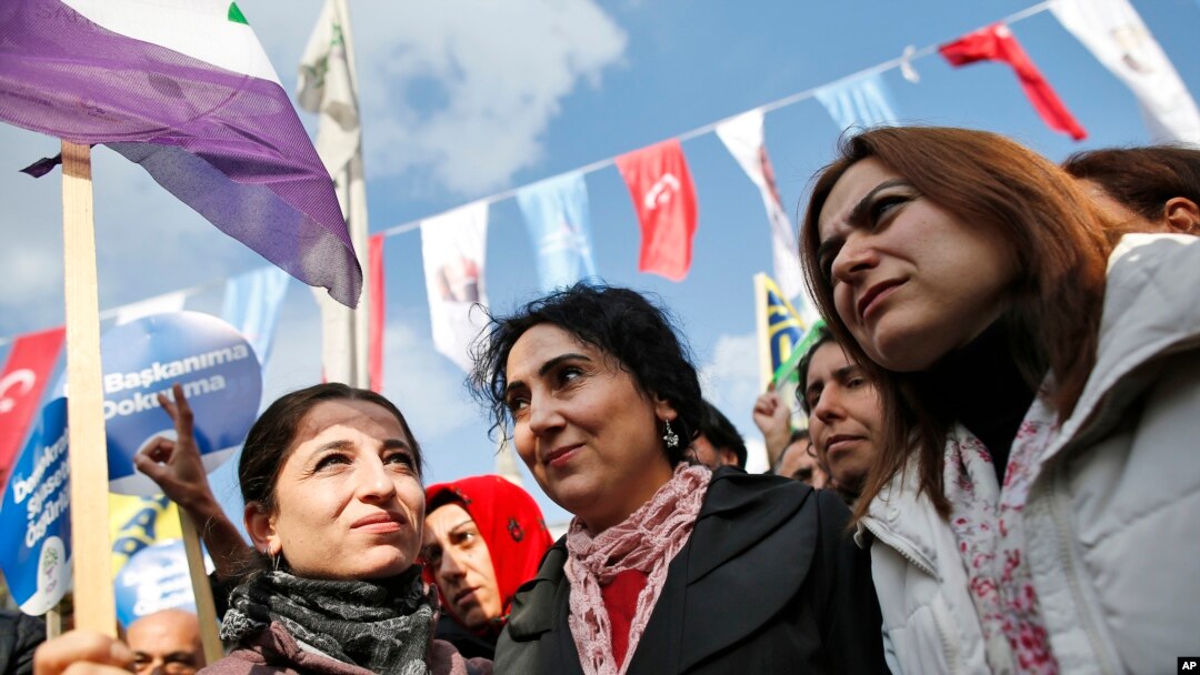 FILE - Figen Yuksekdag, center, co-chairwoman of the pro-Kurdish Peoples' Democratic Party (HDP) , participates in an attempted march that was dispersed by police in Istanbul.