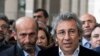 Can Dundar, right, the editor-in-chief of opposition newspaper Cumhuriyet, and Erdem Gul, left, the paper's Ankara representative, speak to the media outside a courthouse in Istanbul, Turkey, Nov. 26, 2015.