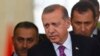 Turkish President Tayyip Erdogan (C) looks on after arriving at Esenboga Airport, in Ankara, June 8, 2015. 