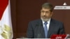 In this image made from a live broadcast on Egyptian State Television, Egyptian President Mohammed Morsi speaks to the constituent assembly in Cairo, Egypt, Dec. 1, 2012.