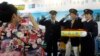 FILE - A Taiwanese visitor poses with uniformed employees of Tokyo Metro Co. for a souvenir photo at the booth of the Tokyo subway company at the Taipei International Travel Fair in Taipei, Taiwan, Nov. 8, 2014. Taiwanese can travel visa-free to 166 countries.