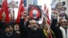 Shi'ite protesters carry posters of Sheikh Nimr al-Nimr during a demonstration in front of Saudi Arabia's Consulate in Istanbul, Turkey, Jan. 3, 2016. 