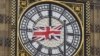 A British Union flag flutters in front of one of the clock faces of the 'Big Ben' clocktower of The Houses of Parliament in central London, Feb. 22 , 2016