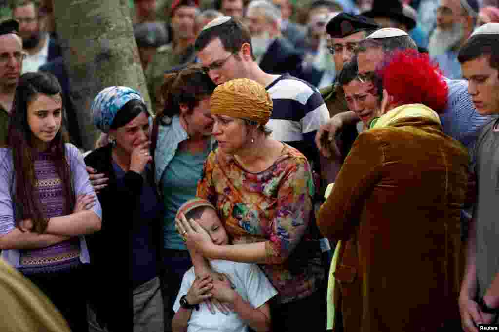 The mother (C) together with other relatives and friends attend the funeral of Israeli soldier Elhai Taharlev, who Israeli military said was killed when a car driven by a Palestinian deliberately rammed two Israeli soldiers, killing Taharlev and injuring another at the occupied West Bank, in Jerusalem.